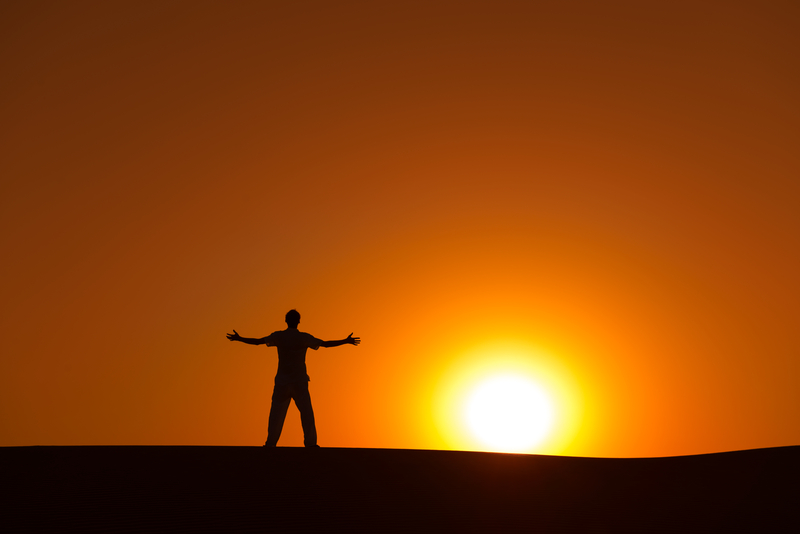 silhouette of a person standing at sunset